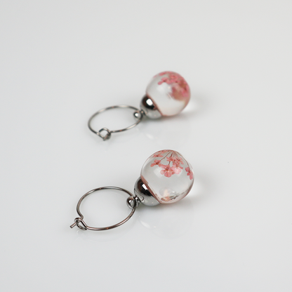 Pair of silver earrings with light pink dill