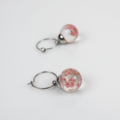 Pair of silver earrings with light pink dill