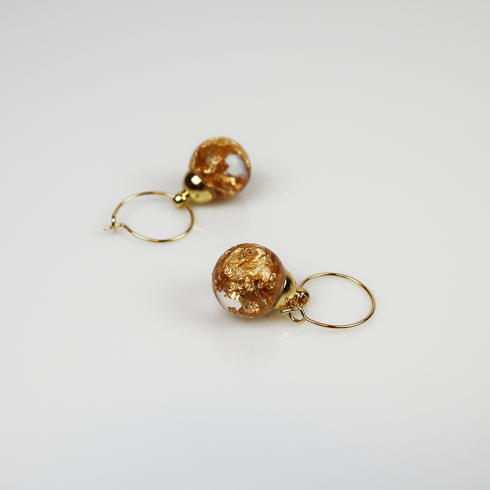 Pair of gold earrings with golden cloud