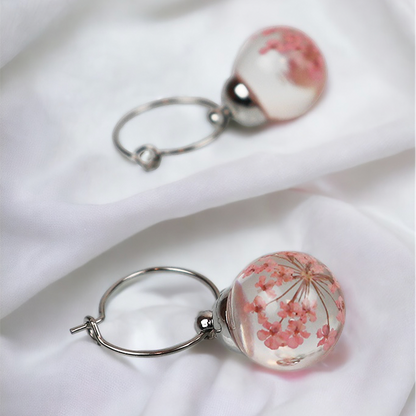 Pair of silver earrings with light pink dill